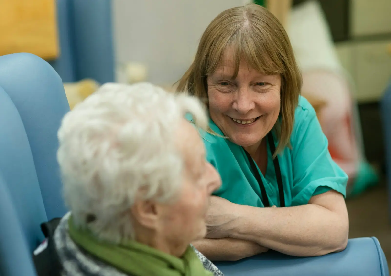 A caregiver chatting warmly with a resident