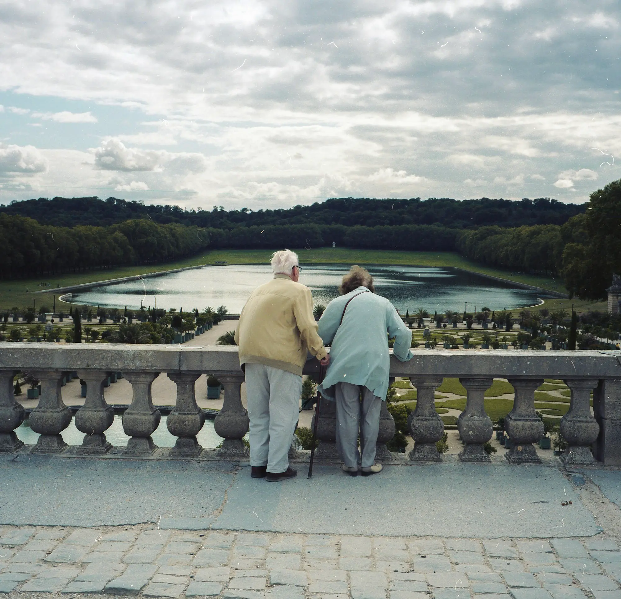 An elderly couple enjoying a peaceful garden view together